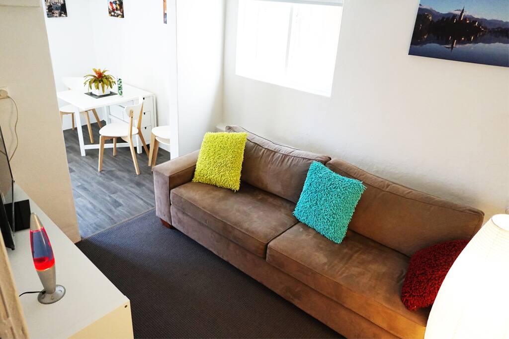living area with tv & dvd player, reading books, board games, lamp and comfortable sofa which can double as a single bed