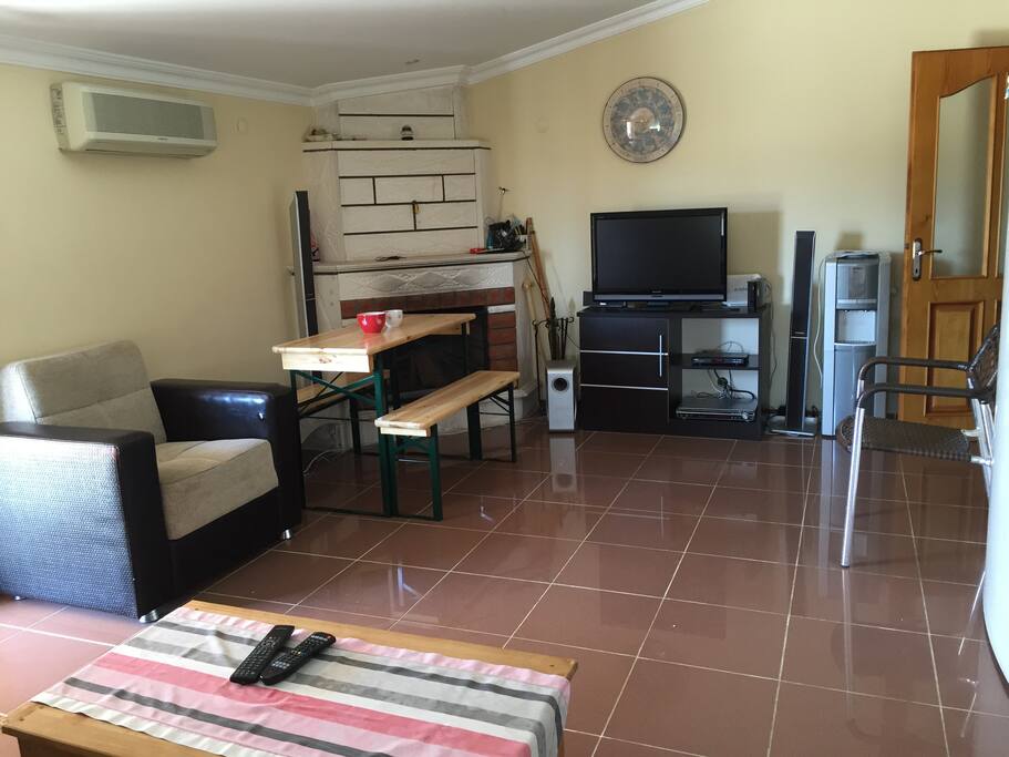 The Living Room with TV, Chimney and confy Sofa set