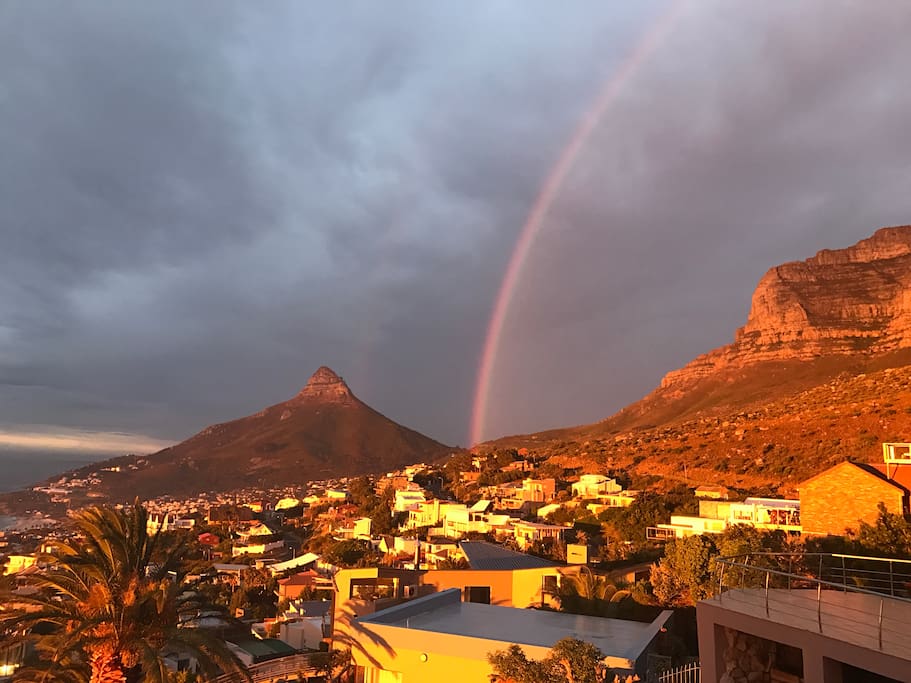 A beautiful rainbow enlites the famous Table Mountain where Bateleurs nestles at the foot of it