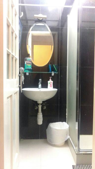 Nice clean shower room with sink, toilet and shower.