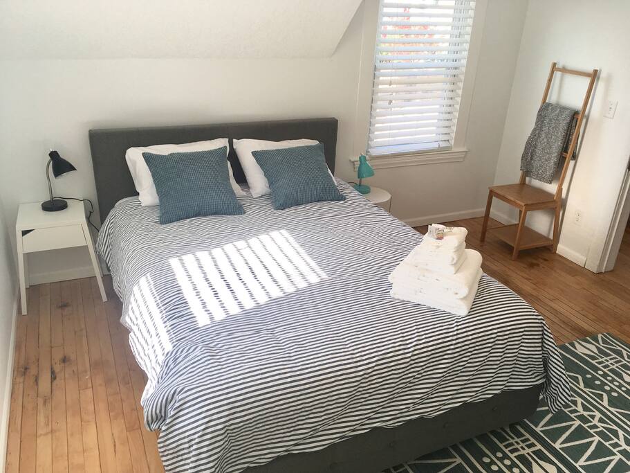 Upstairs master bedroom can accommodate 2 with comfortable queen bed, dresser, ceiling fan, and plenty of closet space.