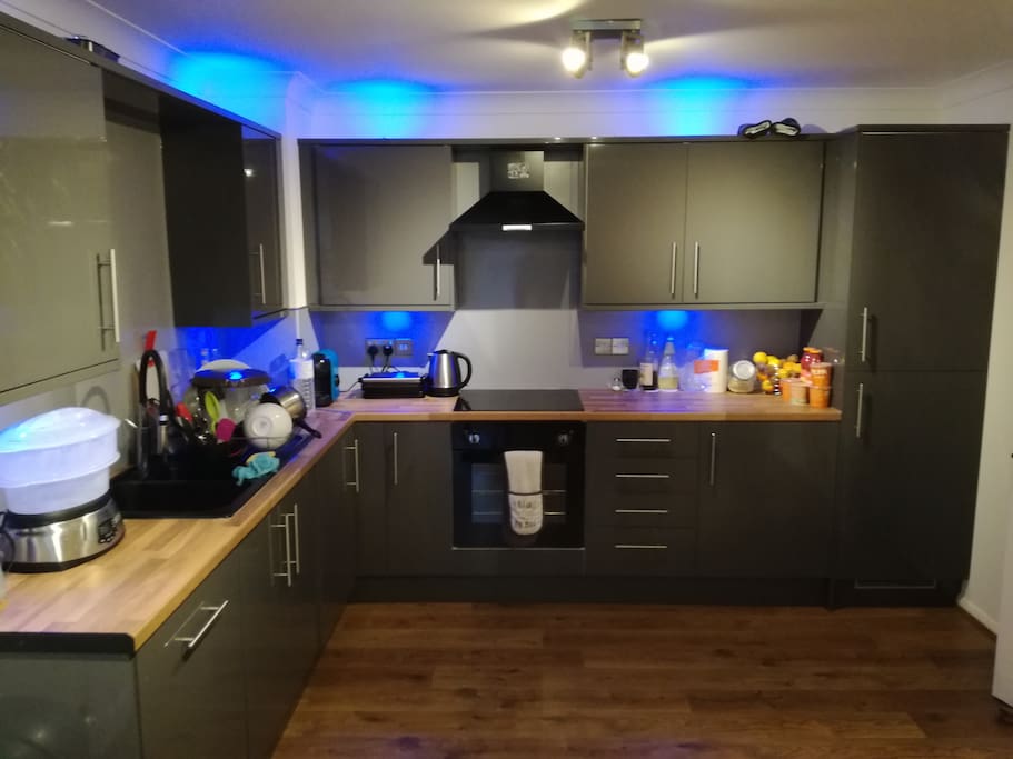 Modern and Luxurious Kitchen with dishwasher, washing machine and dryer.