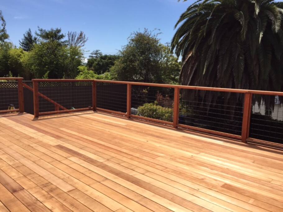 Spacious deck with gardens below and hillside views