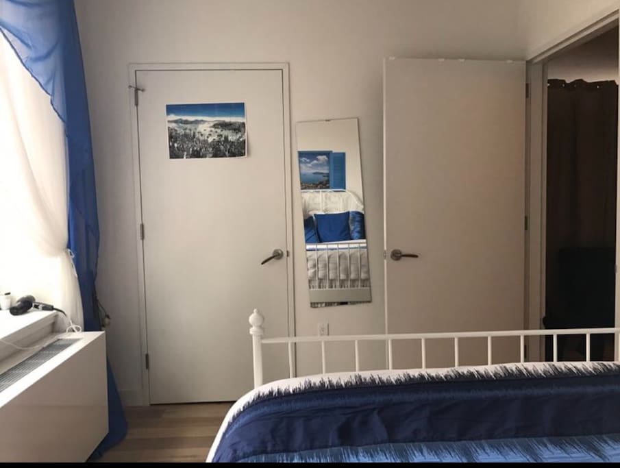 the view of the room from the other side with the closet door (closed)