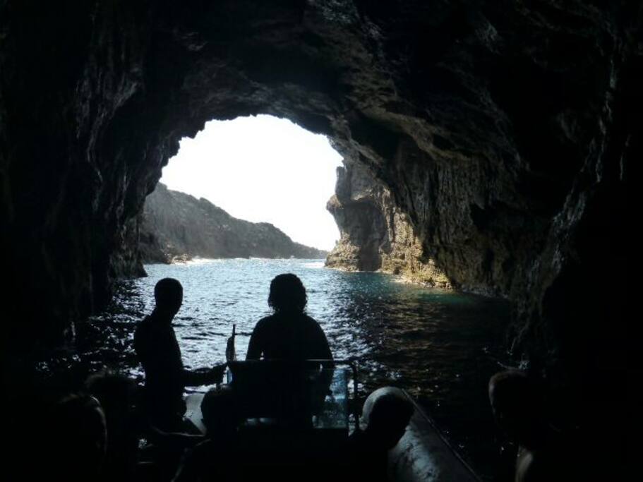 Romantic trip around San Pietro island visiting the sea caves with an aperitif....