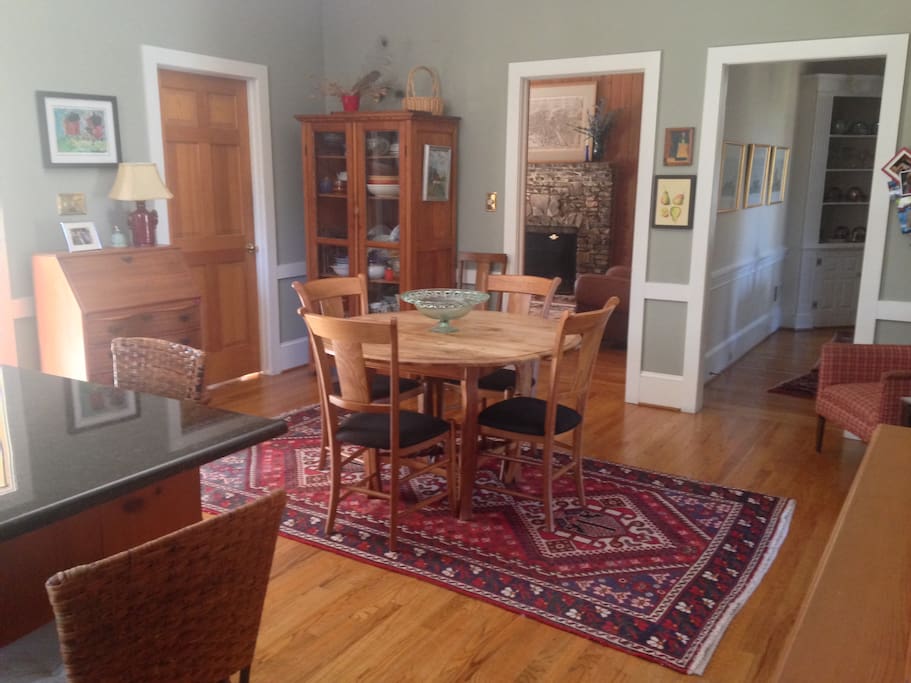Large kitchen with dining area and island with 3 stools