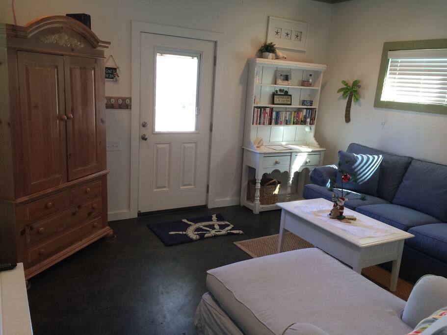 Front room, sofa makes out to a bed, tv in cabinet.