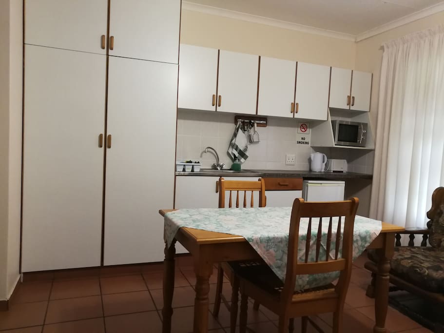 Kitchenette with stove, microwave, Bar fridge, crockery & cutlery