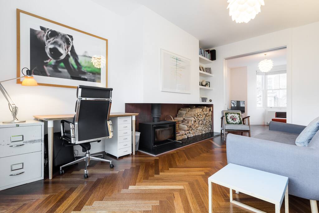 The ground floor living area features a modern wood-burning stove.