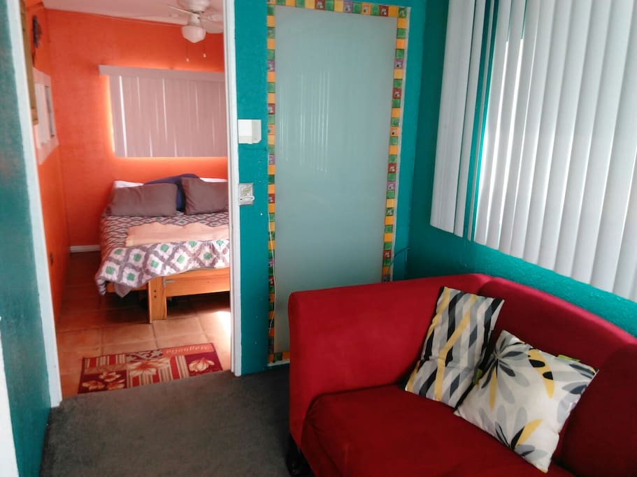 Main seating area, looking towards front bedroom. Note the custom, traditional style of the Mexican tiles along all sides of the opaque window.