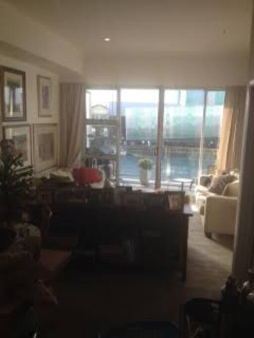 Living room looking out to front patio and barbeque