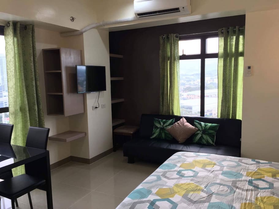 Sofa bed looking out to beautiful views of Cebu City and flat screen cable TV.