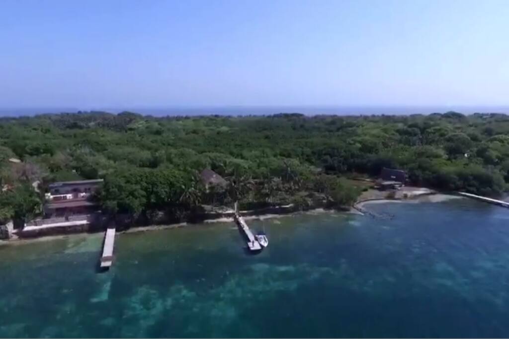 View from the sky. You can see the virgin transparent sea and the private dock. This photo shows the dimension of Isla Grande, and the green natural environment it offers.