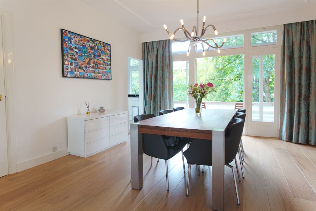 Large dining room with a table for 6 people plus a high chair and a booster seat for small children.