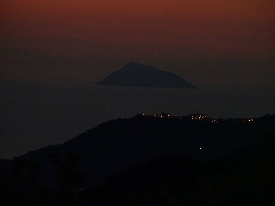 At night, the red sky's outline the volcanic islands.