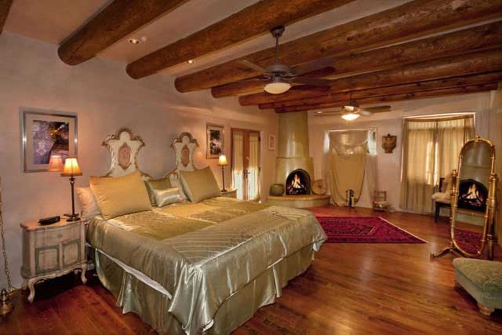 The master bedroom is fit for royalty with a specially designed bed and wood-burning kiva fireplace.