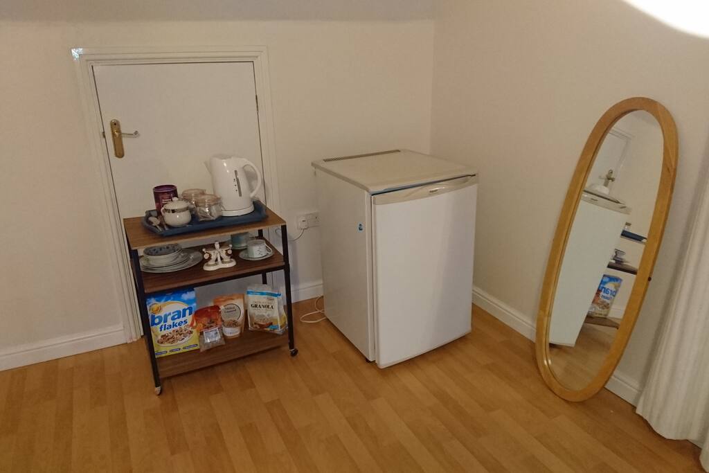 Standing mirror refrigerator and breakfast supplies.
