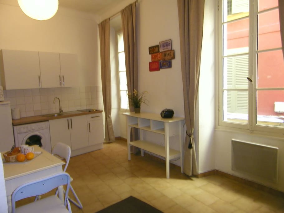 Two large windows and high ceilings make the studio feel spacious