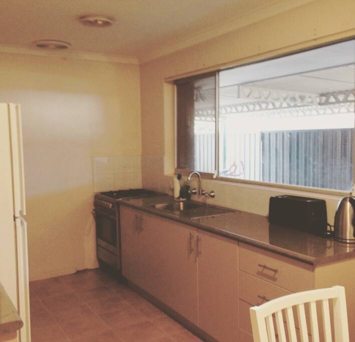Kitchen with outlook onto rear alfresco