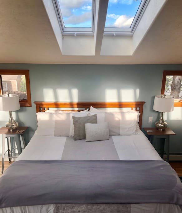 Deluxe King bed. Cozy yet airy, with lots of natural light.