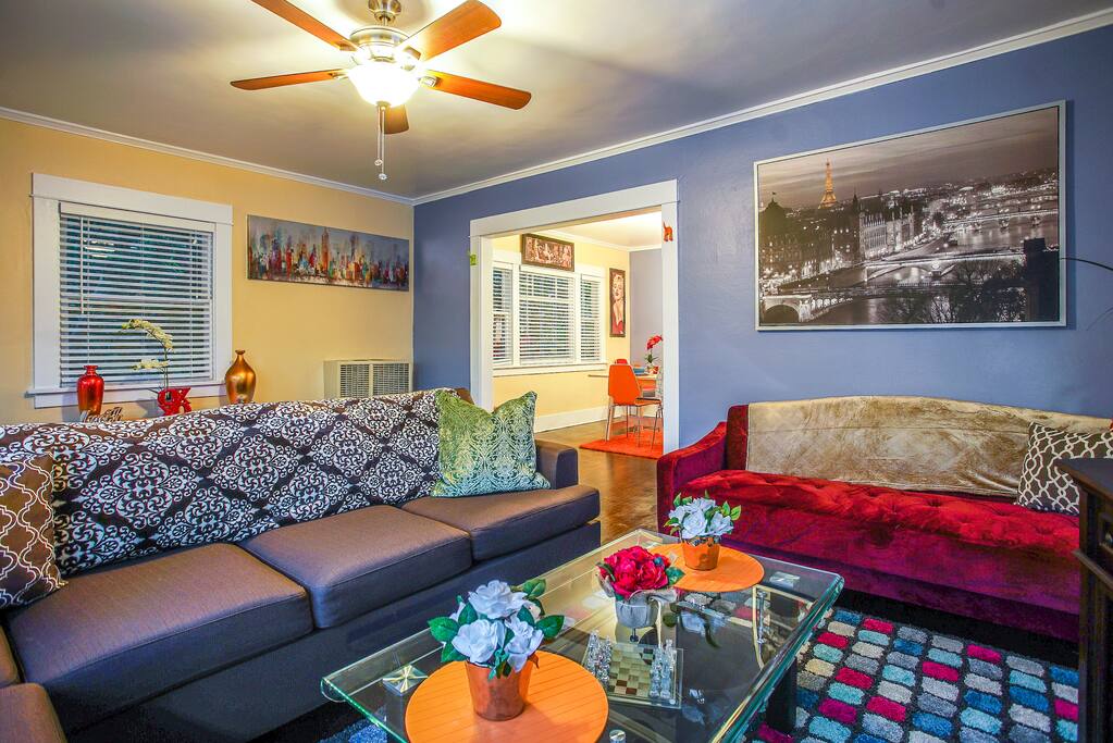 The living room includes comfy sofas, one of which converts into a full-size sofa bed