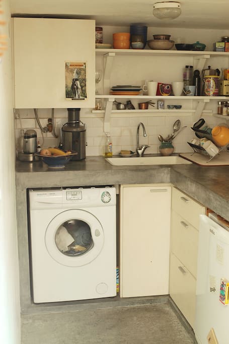 Kitchen has a washing machine.