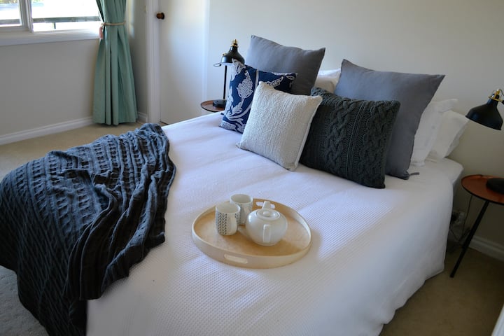 You can have your tea or coffee in the morning while still relaxing in this clean bedroom.