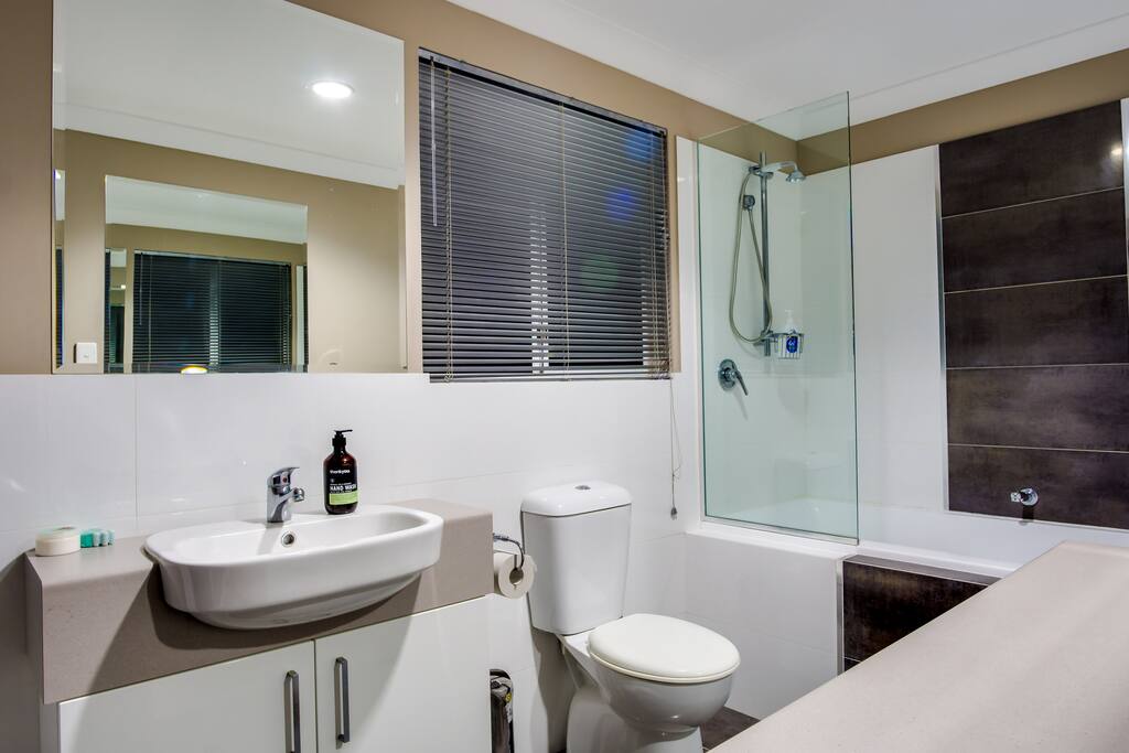 Beautiful ensuite with an ocean view from the shower/bath.