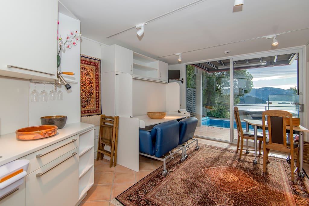 Studio: view towards terrace & pool. Double bed folded with desk in working position