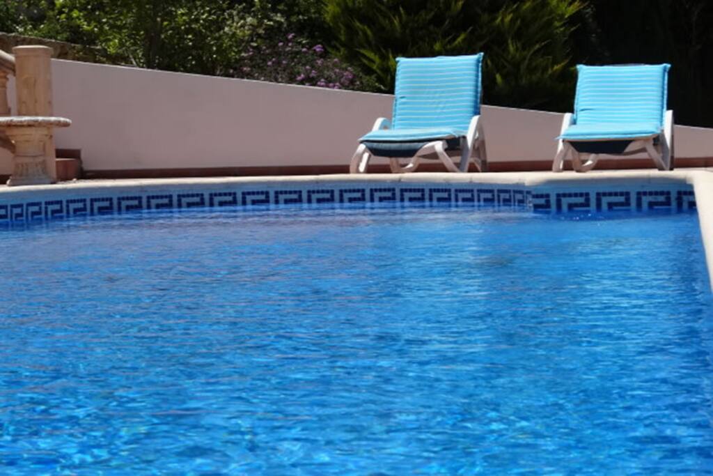 Private pool with sun loungers.