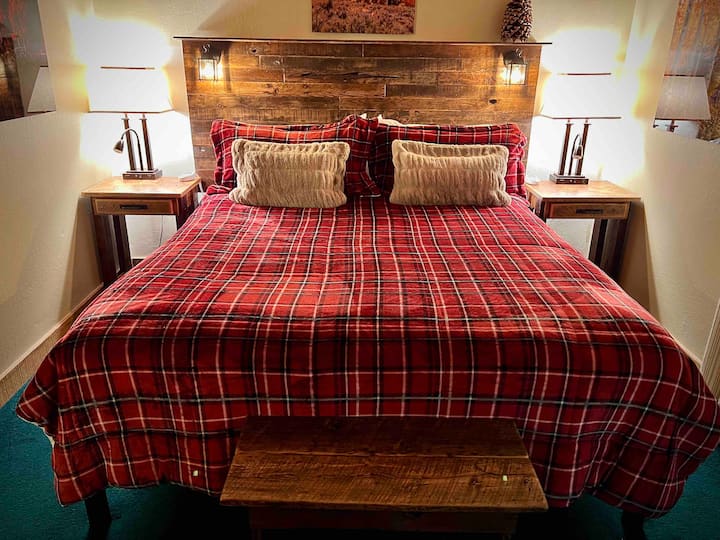 Sleep deeply in the California king bed, with a luxurious mattress topper on heated bedding. The bench is reclaimed barnwood made by a local woman.