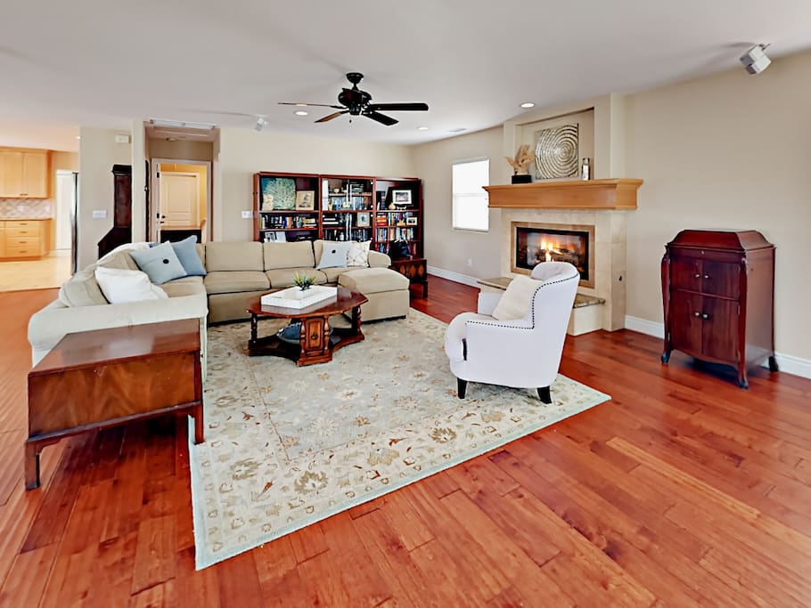Open living area features hardwood floors and seating for 8.