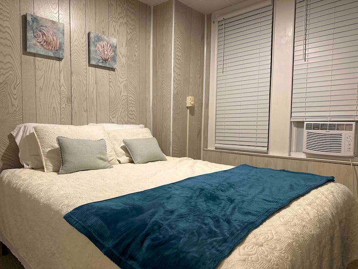 The back bedroom features a comfy queen sized bed and a full-length closet. 