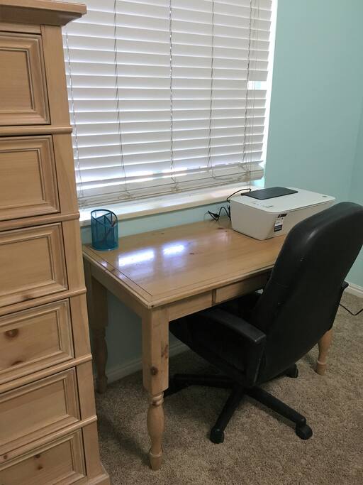 The small work desk in blue bedroom is a great place to study or catch up with work.