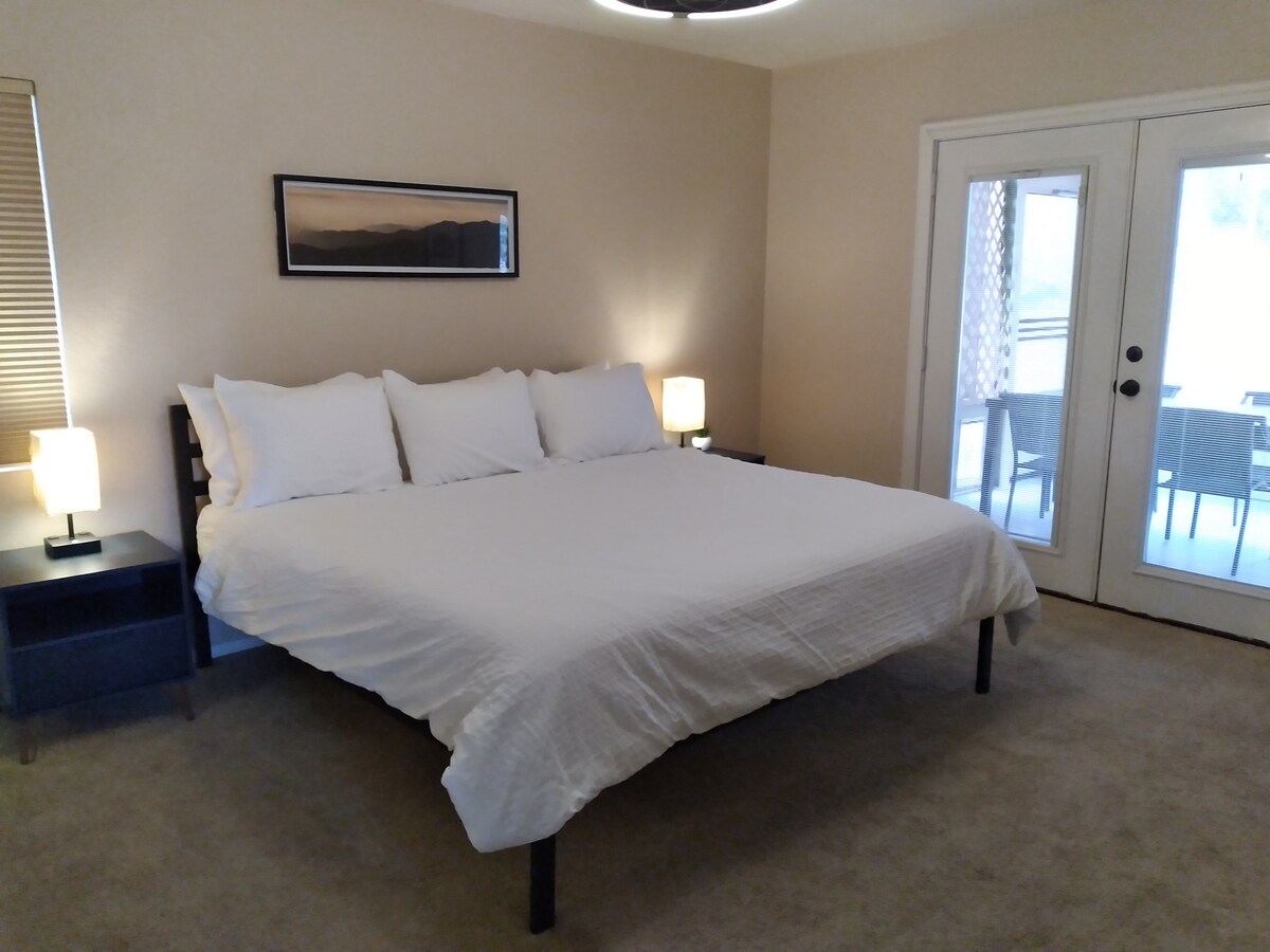 The main floor bedroom is at the center of it all.  A  king, a variety of pillows, and remote controlled ceiling fan are there to help make the perfect sleep.   Double door access to the backyard porch where fresh mountain air await each morning.   