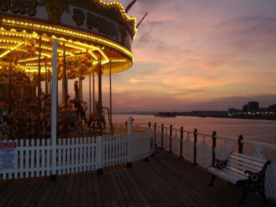View of the Brighton Pier carousel on a summer's evening.