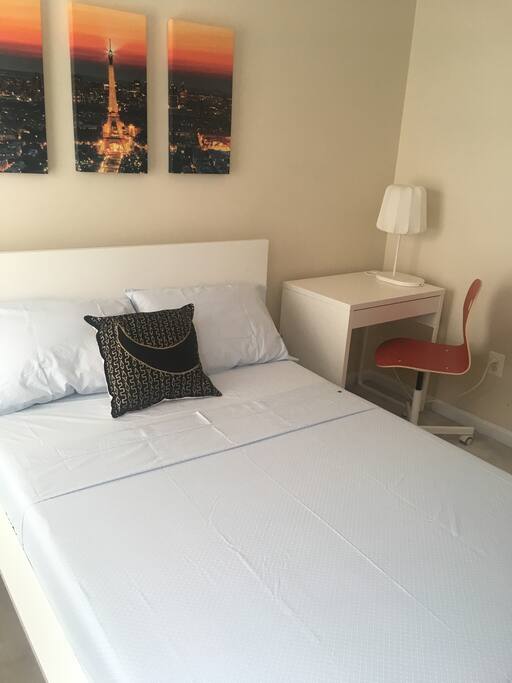 Guests bedroom with an office desk.
