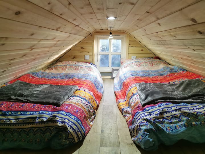 Single / Double loft bedroom with individual plug sockets and cosy throws.
