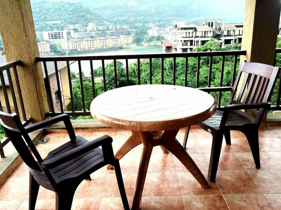 Lake view facing Balcony of one of the rooms along with movable chairs n tables...