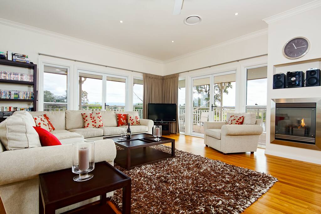 Open plan lounge area with gas fireplace. Seating for 8.
