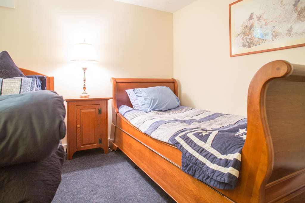 Twin bed next to the two full beds in your cozy room.