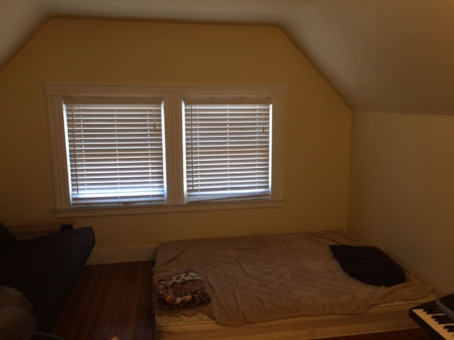 This is the other room with a bed and a futon.