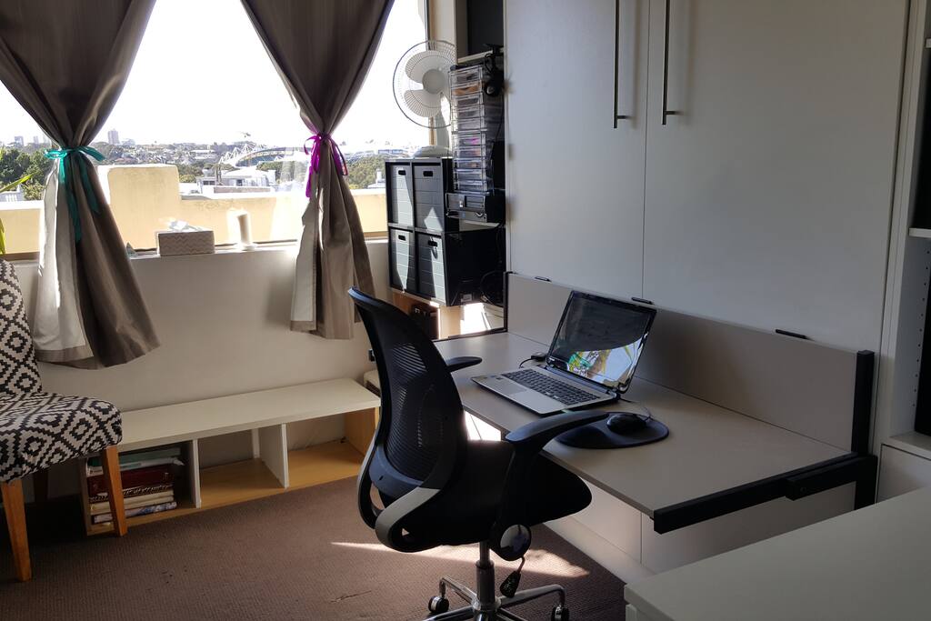 Pull the handles, the desk closes and down comes the bed