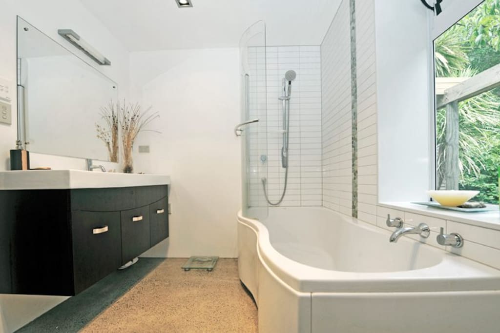 Private use of luxury bathroom with shower and bath.