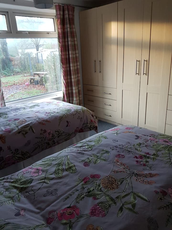 Twin bedroom with large amount of storage and tv 
