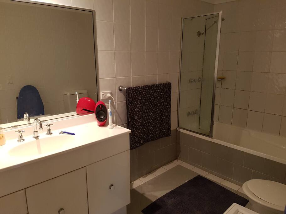 Large bathroom with combined shower and bath.