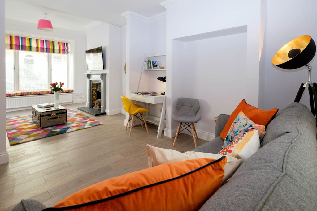Big open lounge with double sofa bed, sofa, desk and TV