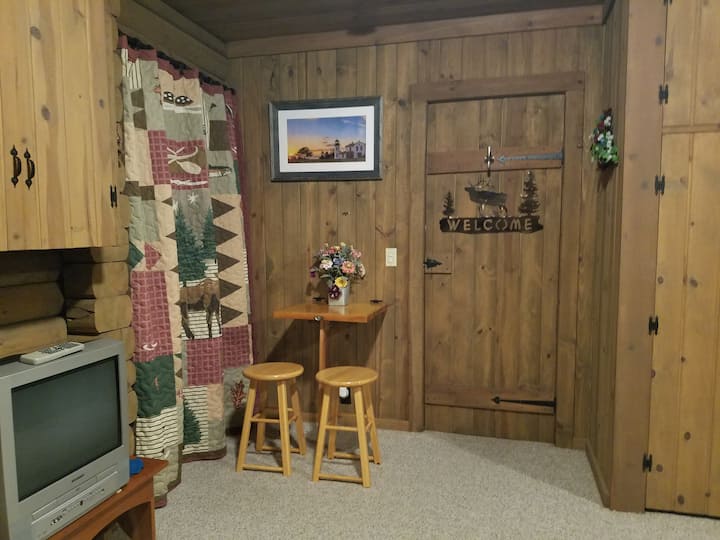 Cozy and quiet small breakfast nook. A fold out four seating table is tucked away in the library for use outside or in.