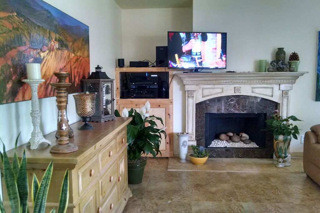 Family room with gas fireplace and flat screen tv w large leather couch
