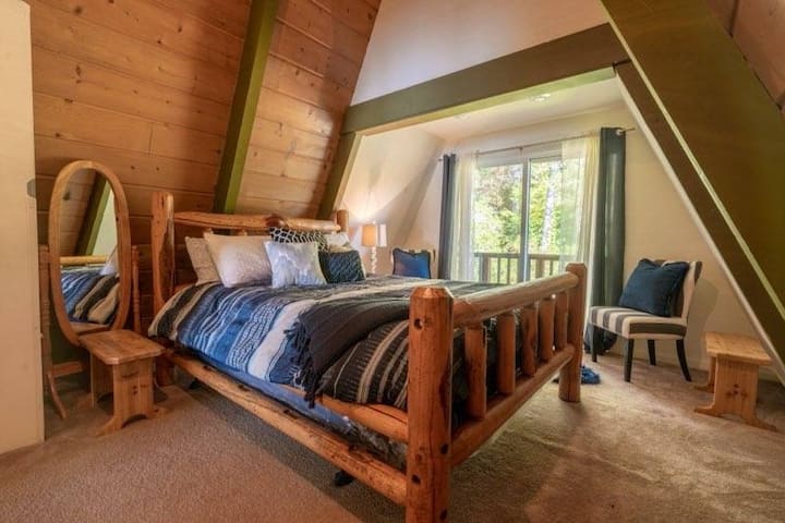 Large upstairs master bedroom has a Queen bed with sitting area and small deck with bar height chairs overlooking the yard.  Flat screen TV with ROKU.  Queen air bed in Master closet to accommodate 6th & 7th guests as desired.   